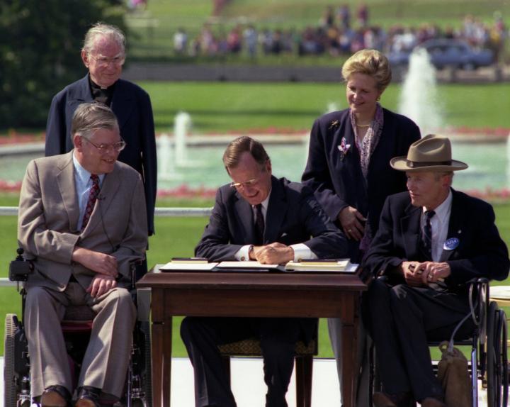 President George H.W. Bush signing the American with Disabilities Act on July 26, 1990