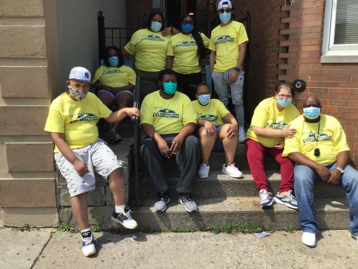 Group shot of people from YAI's East Tremont location, all wearing yellow Central Park Challenge Shirts