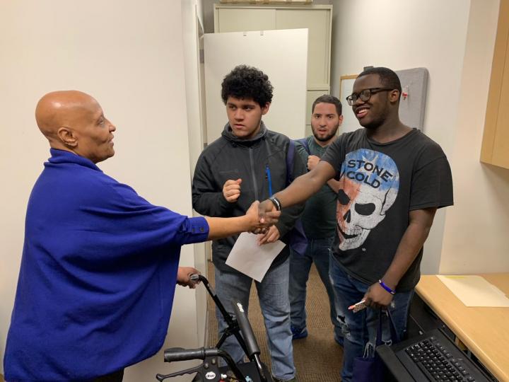 Office Assistant Berta Land greets a group of visiting students