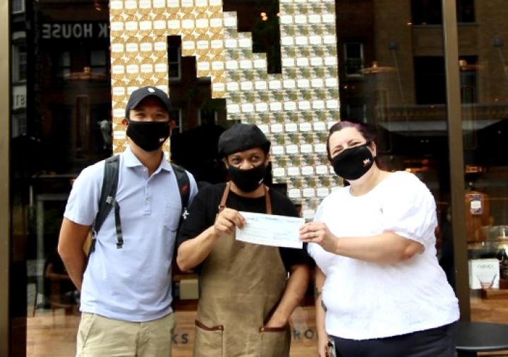 Andre Williams (middle) stands with Laney Alfaro (right), and Jesse Bernardez (left) in front of Starbucks Roastery-Chelsea