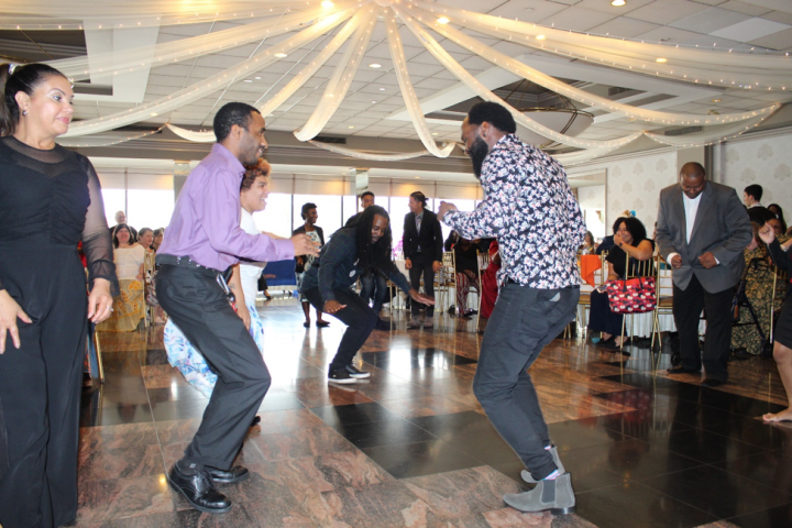 People dancing and smiling. Staff from YAI’s Queens region hold a dance-off at last year’s DSP recognition event.