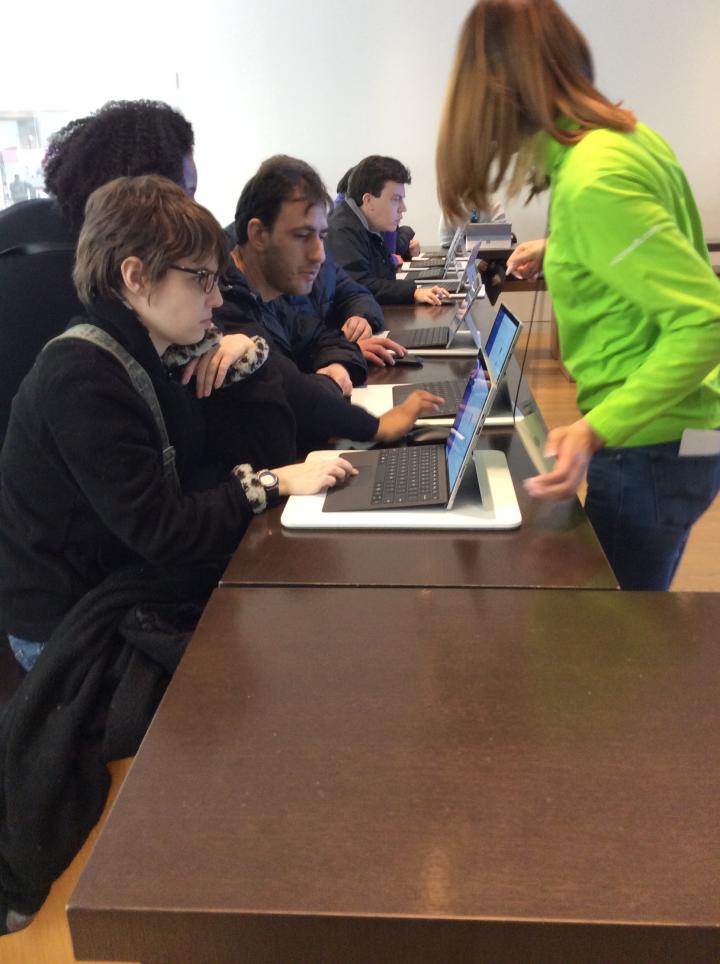 Photograph of people sitting at computers