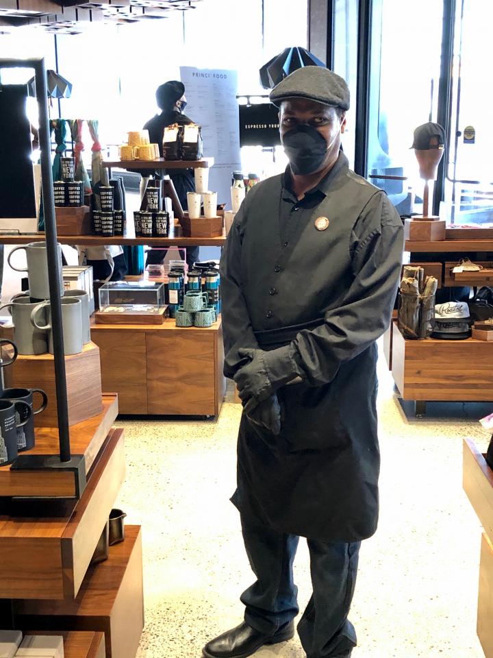 Andre Williams returned to work last month. He stands in the merchandise area of the Roastery.