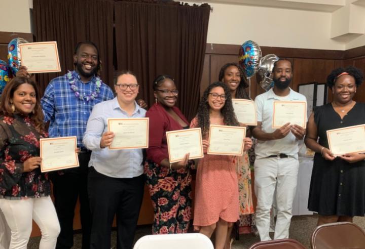 Group of people holding certificates