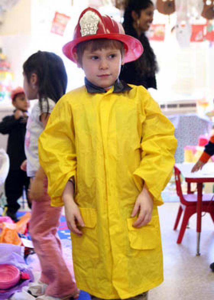 Boy wearing fireman costume