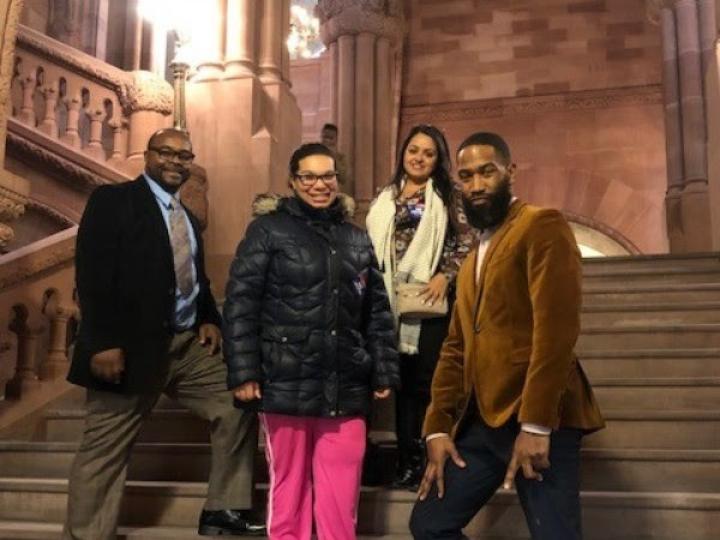 2 men and 2 women standing on the steps of the assembly chamber