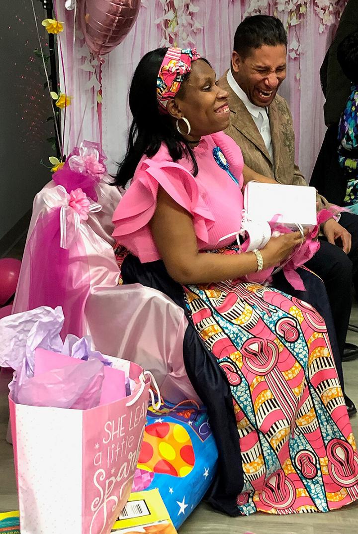 Tanzanika Rosado and her husband open gifts at their baby shower.