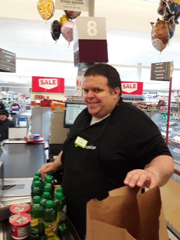 Richard working at a cash register