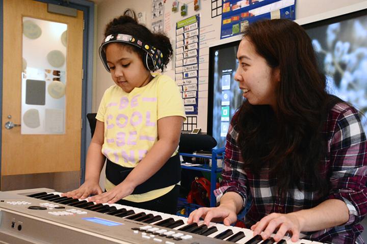 Student playing keyboard with MSA’s Musical Therapist