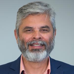 Ravi Dahiya - Chief Program Officer Ravi Dahiya wearing dark blue suit and peach shirt