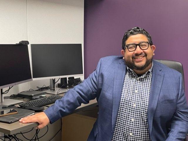 Joshua Trinidad sits in his office at YAI Headquarters.