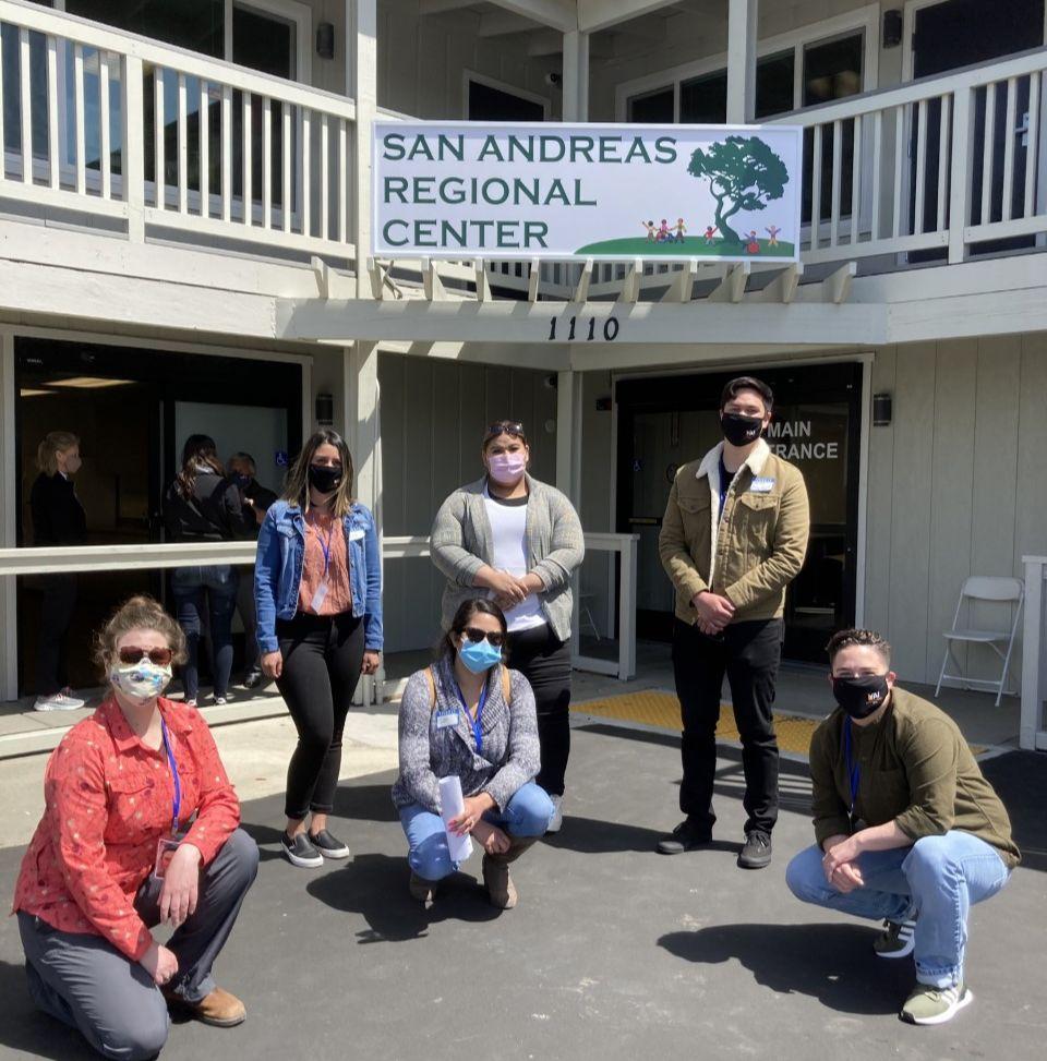 Six people posing in front of the San Andreas Regional Center