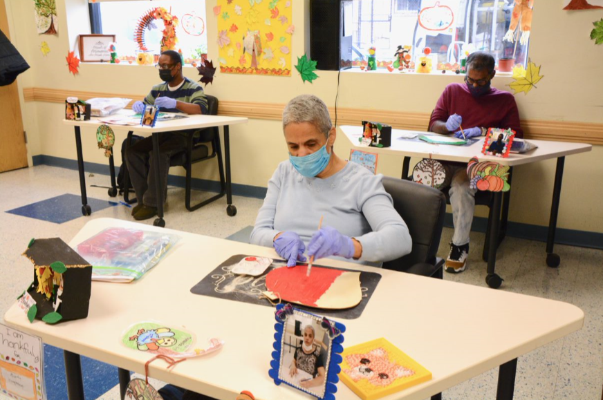 Three people doing arts and crafts