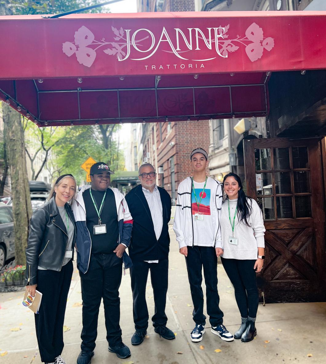 Group of interns and support staff stand outside Joanne an UWS restaurant