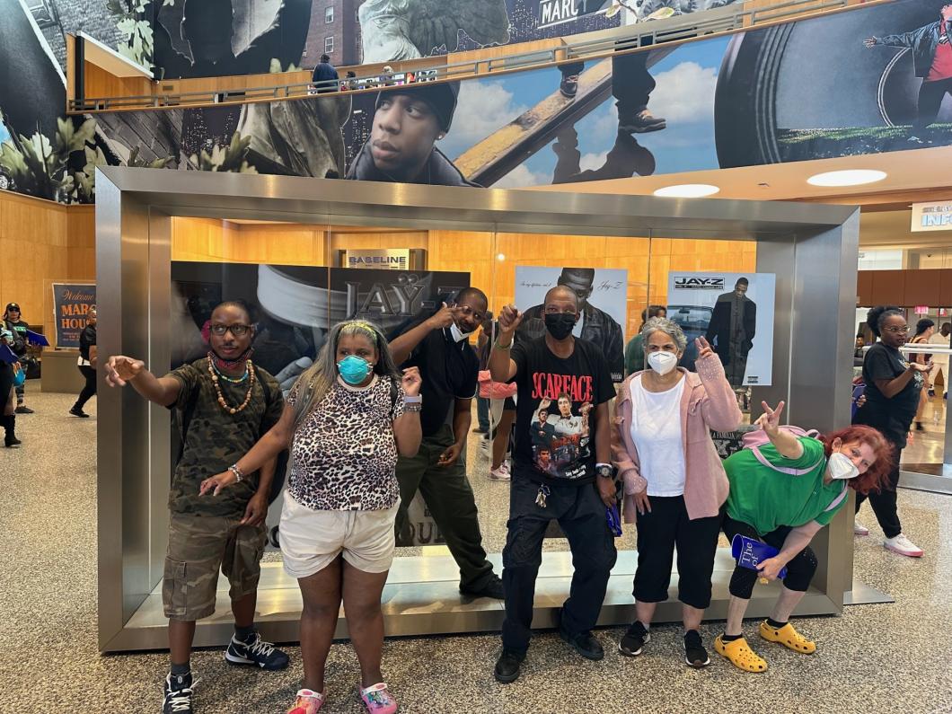 Group of people pose at the Jay-Z exhibit in Central Library, Brooklyn