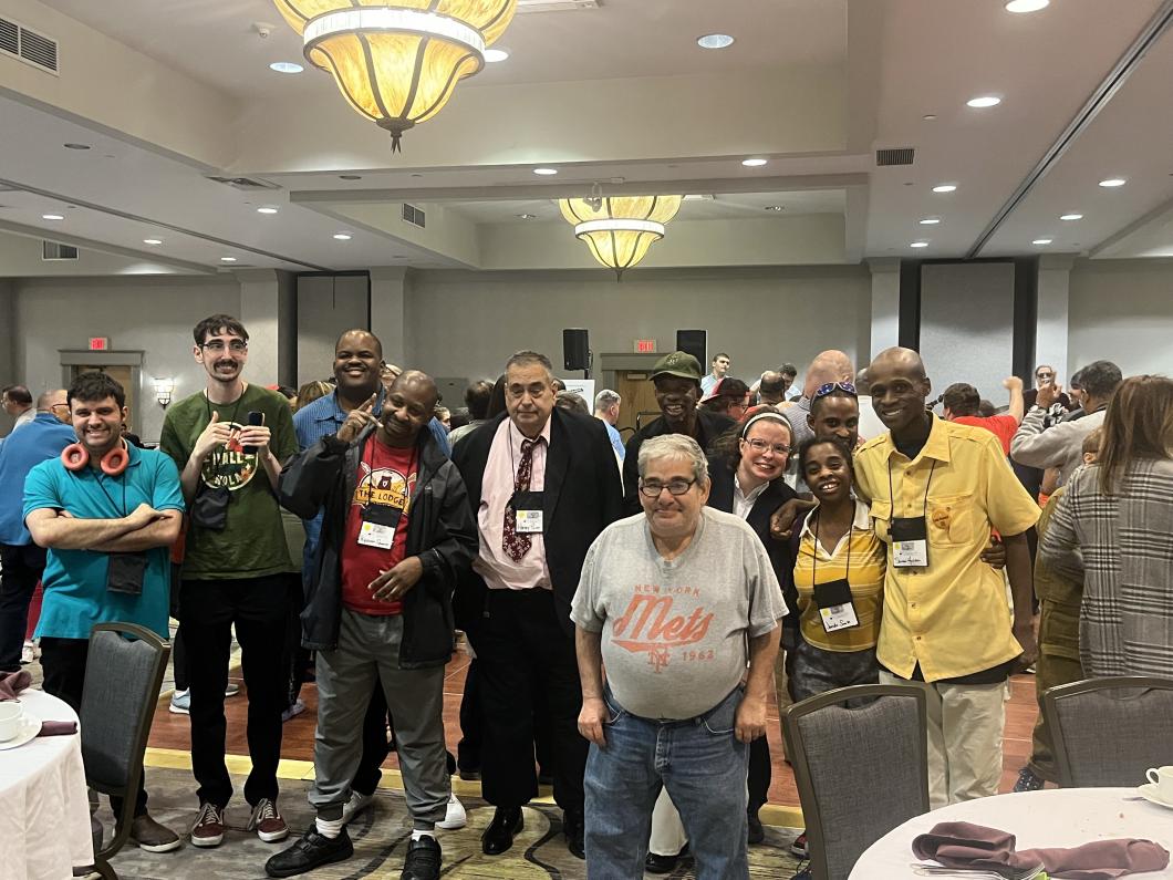Group of self advocates pose for photo in the hotel
