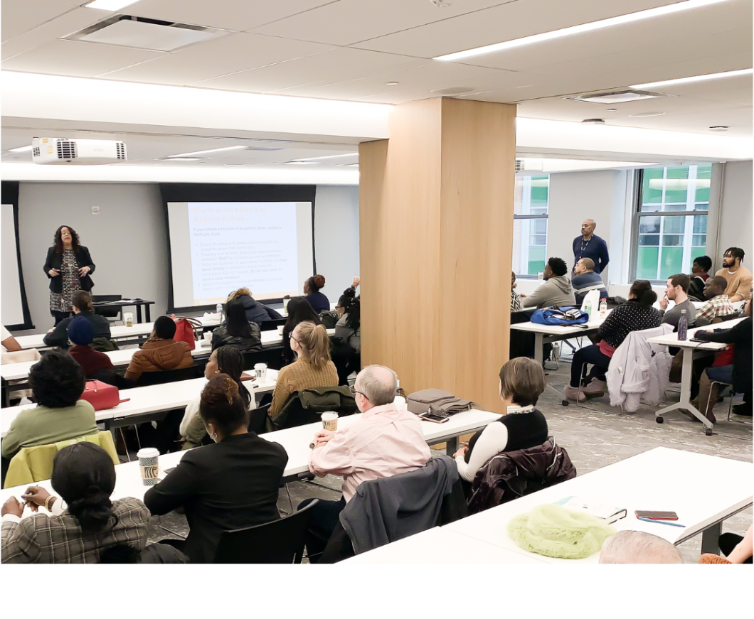 People sitting in a large room in a training