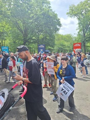 Many people holding signs and waiting for the 3k walk to start at the Central Park Challenge 2025