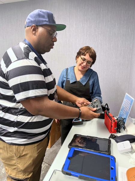 Two people look at some specialized technology at the Center for Innovation