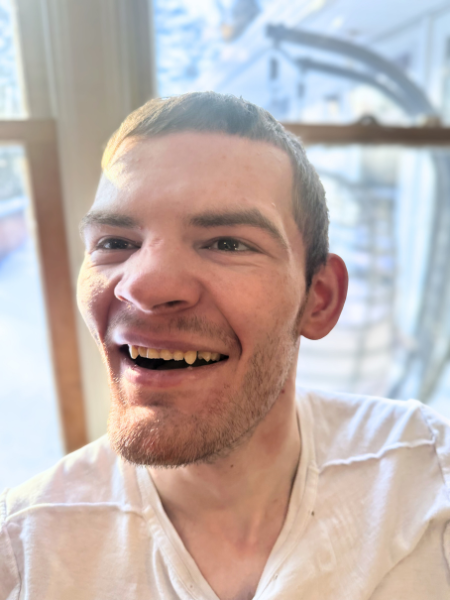 Logan has a big smile in this portrait photo