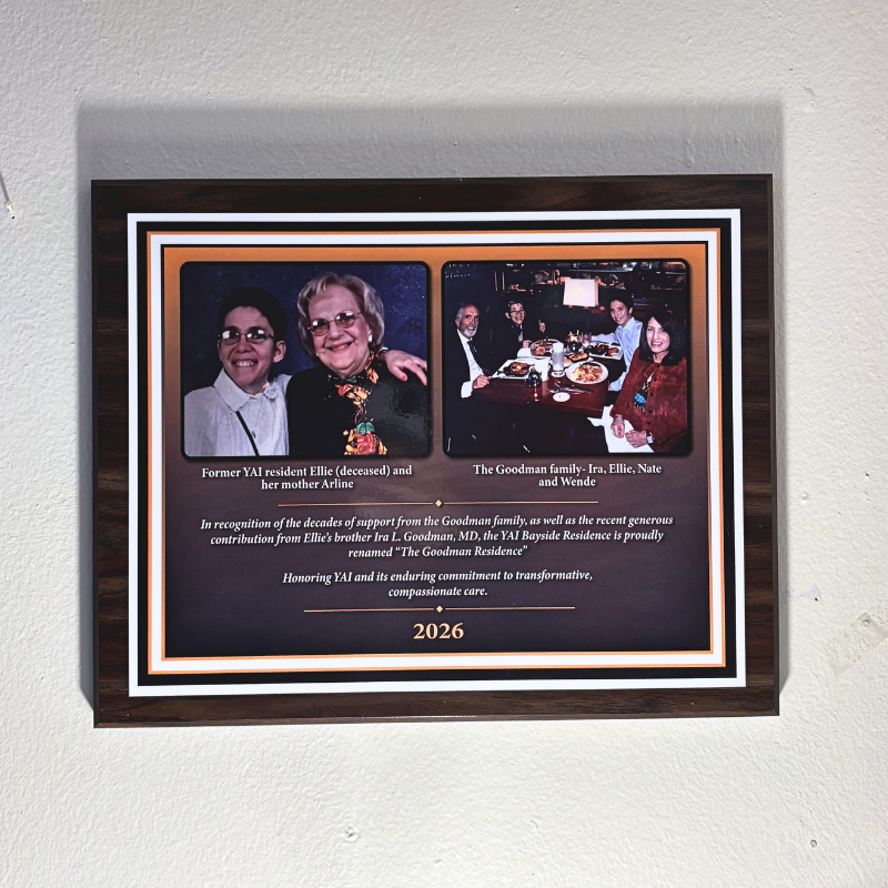 Dedication plaque with 2 photos, one of Ellie with her mother and one with her siblings at a restaurant. Dedication is to her and her family for the generous support.