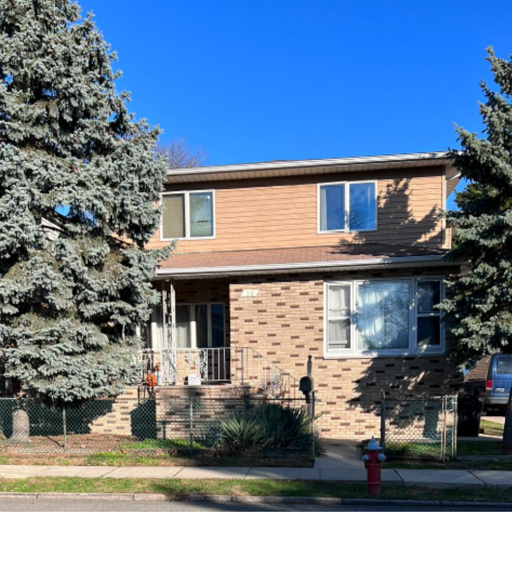 exterior of a residential home with trees around and blue sky