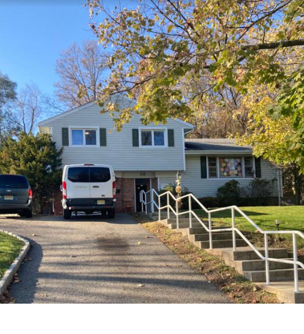 Exterior of a house, up a fairly long driveway