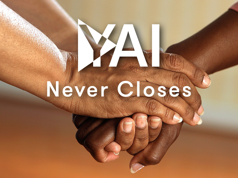 Close up of 2 hands held together. Overlay is "YAI [logo] Never closes"
